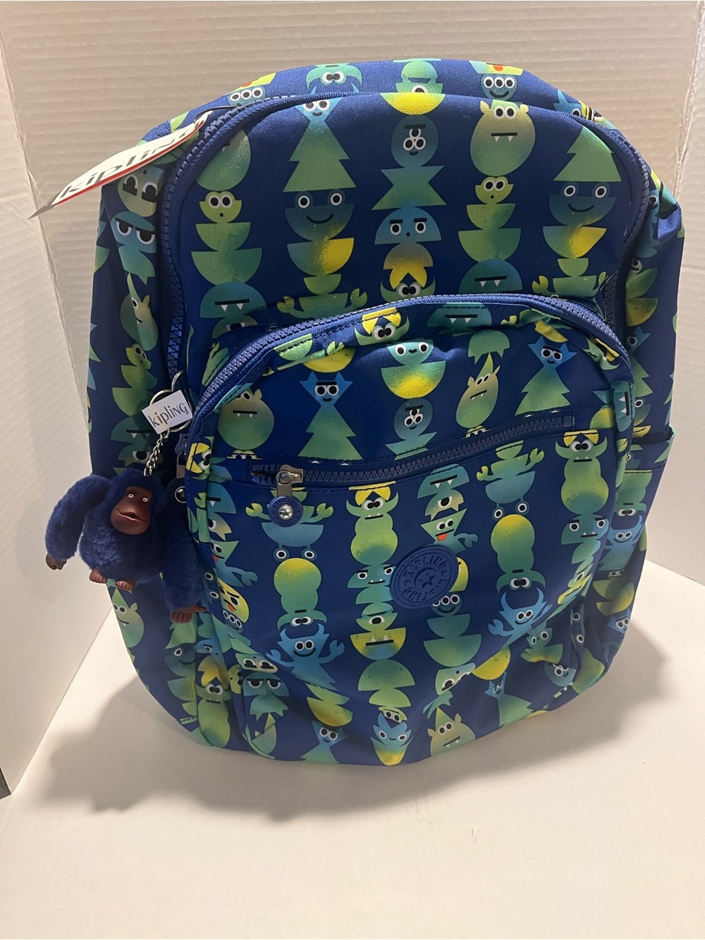 Kipling Seoul Laptop Backpack featuring a "Monster March" pattern